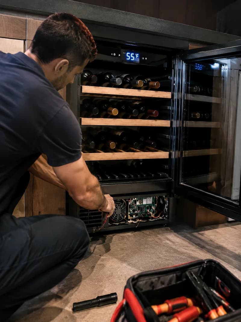 Solvanta technician repairing the cooling module on an undercounter wine cooler