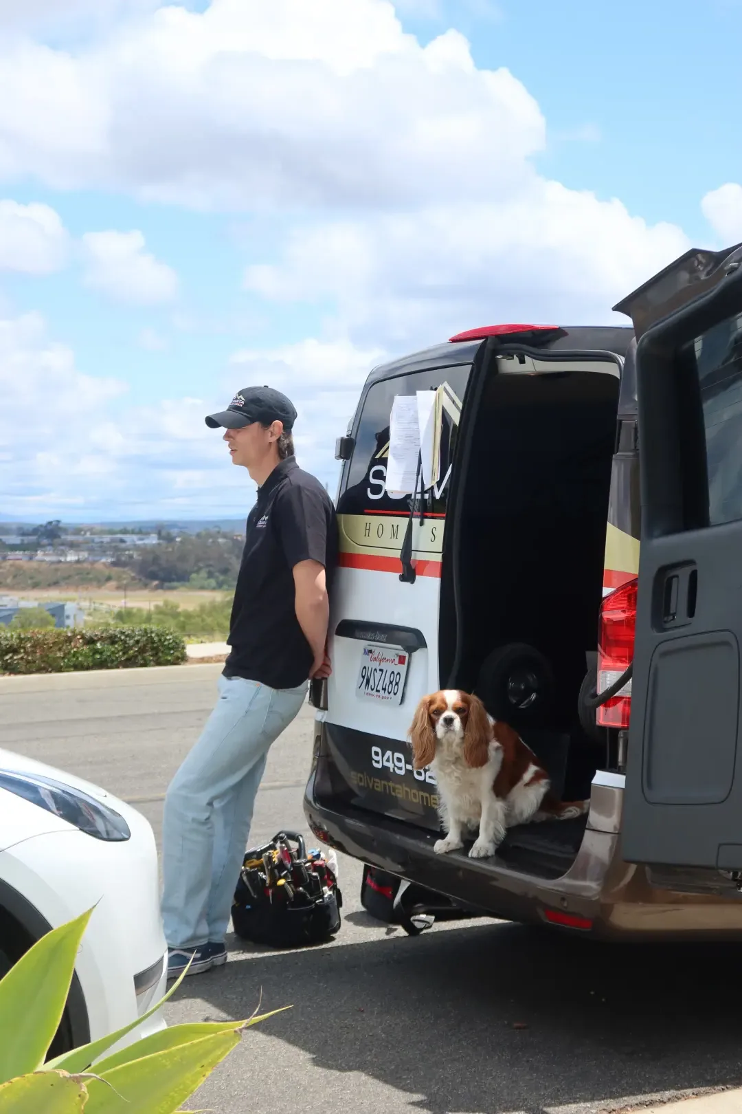 Solvanta technician at the open van with the office dog