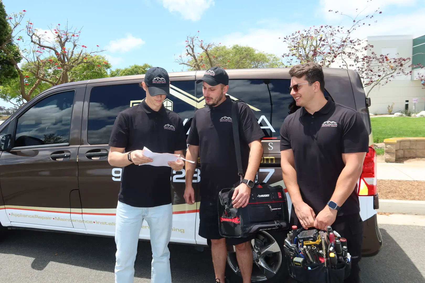 Solvanta repair team with tool bags next to the company van