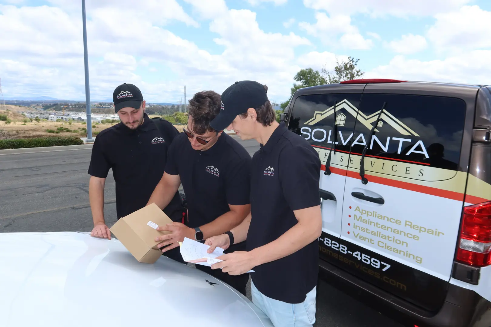 Solvanta technicians checking parts at the back of the van