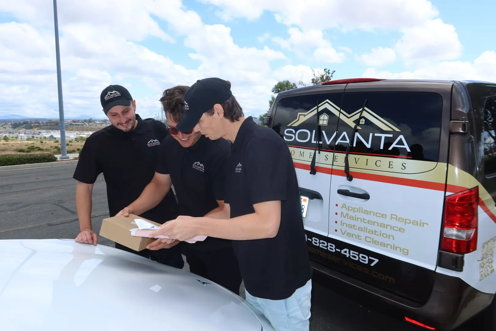 Solvanta technicians preparing parts for an appliance repair